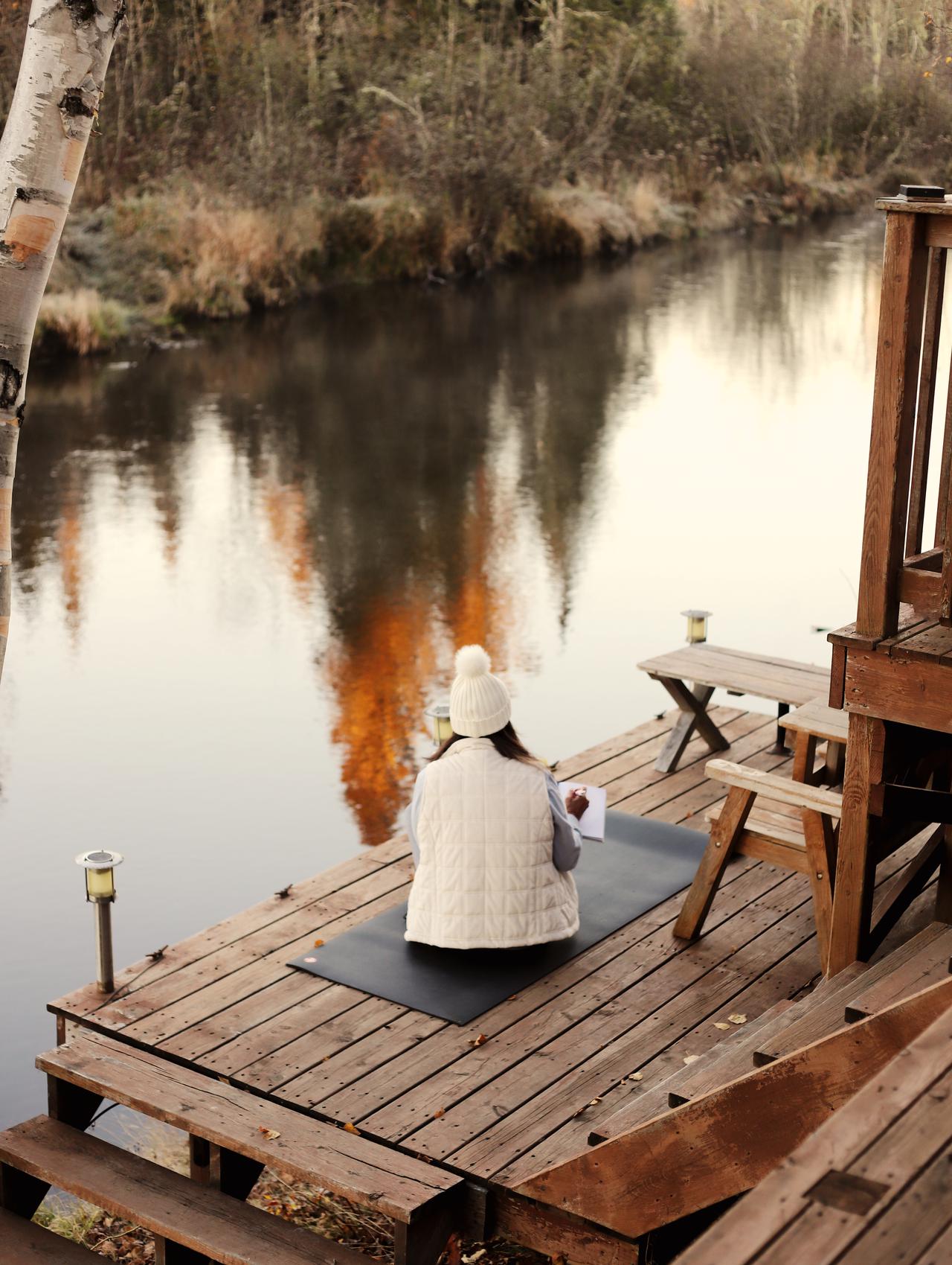A guest relaxing on the riverside deck